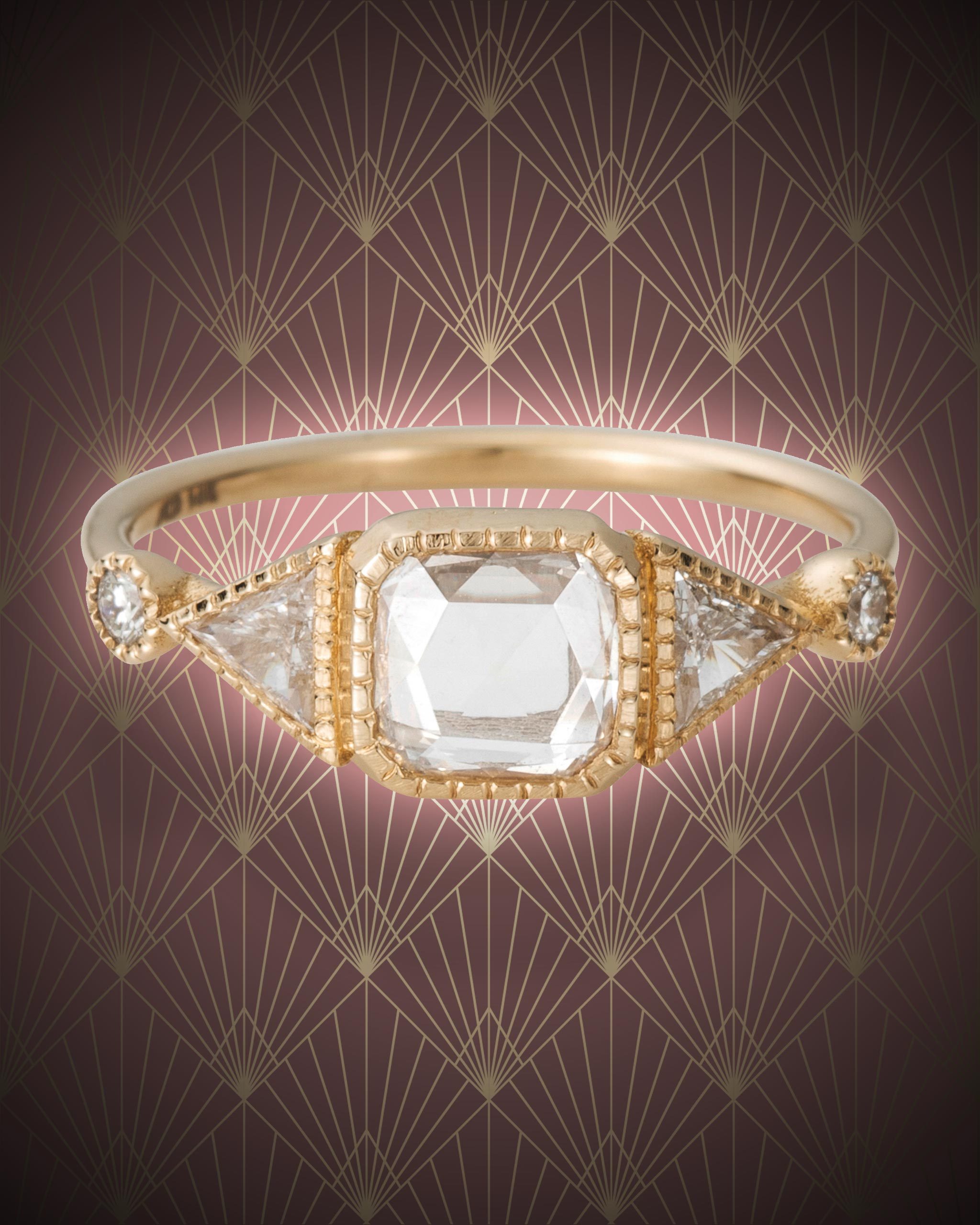 Square cut diamond Art Deco ring hugged by trilliant & round cut diamonds on a yellow gold from Jennie Kwon