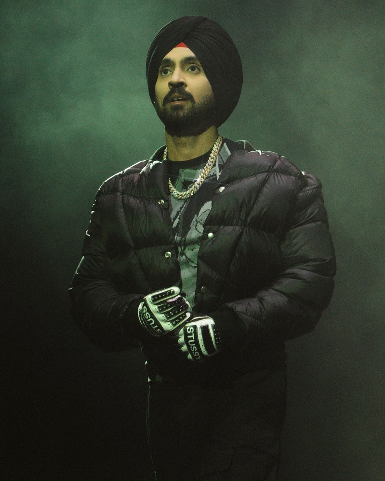 Diljit Dosanjh rocking a diamond-encrusted Cuban chain, blending royalty with hip-hop style